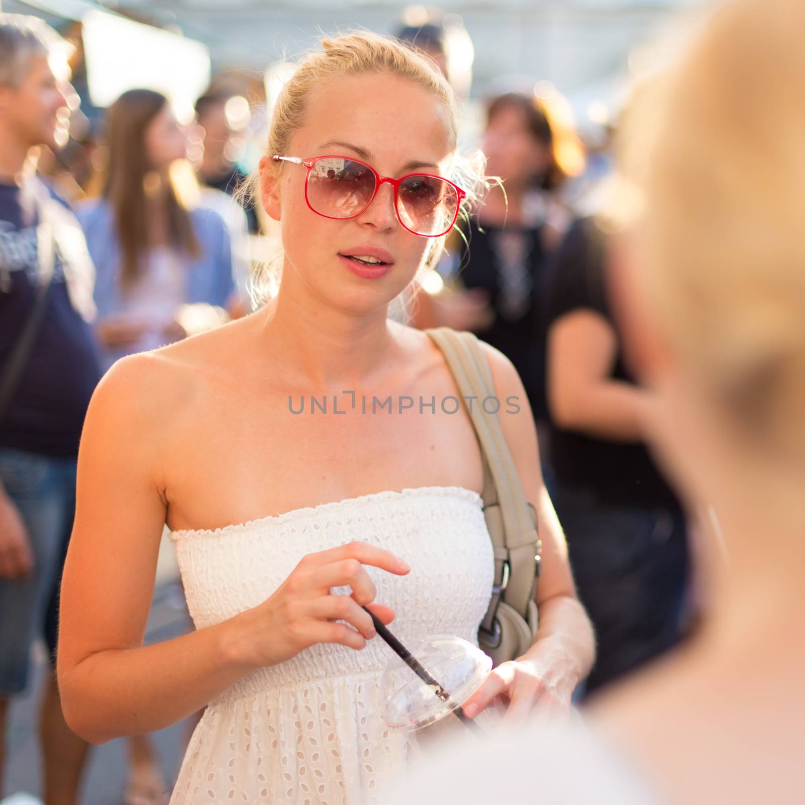 Female friends enjoying a conversation on market. by kasto