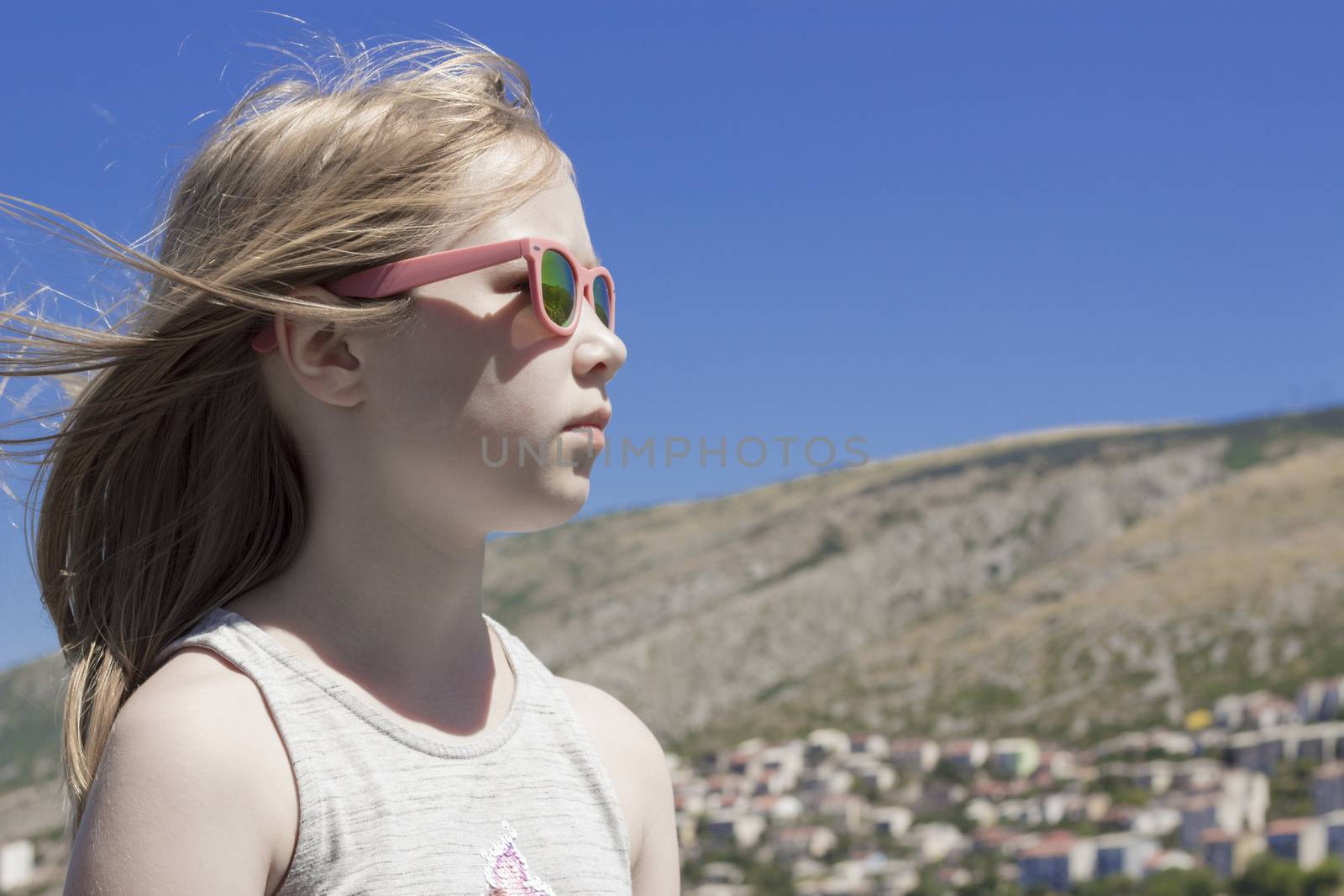 Little Girl on background of blue sky and mountain by gstalker