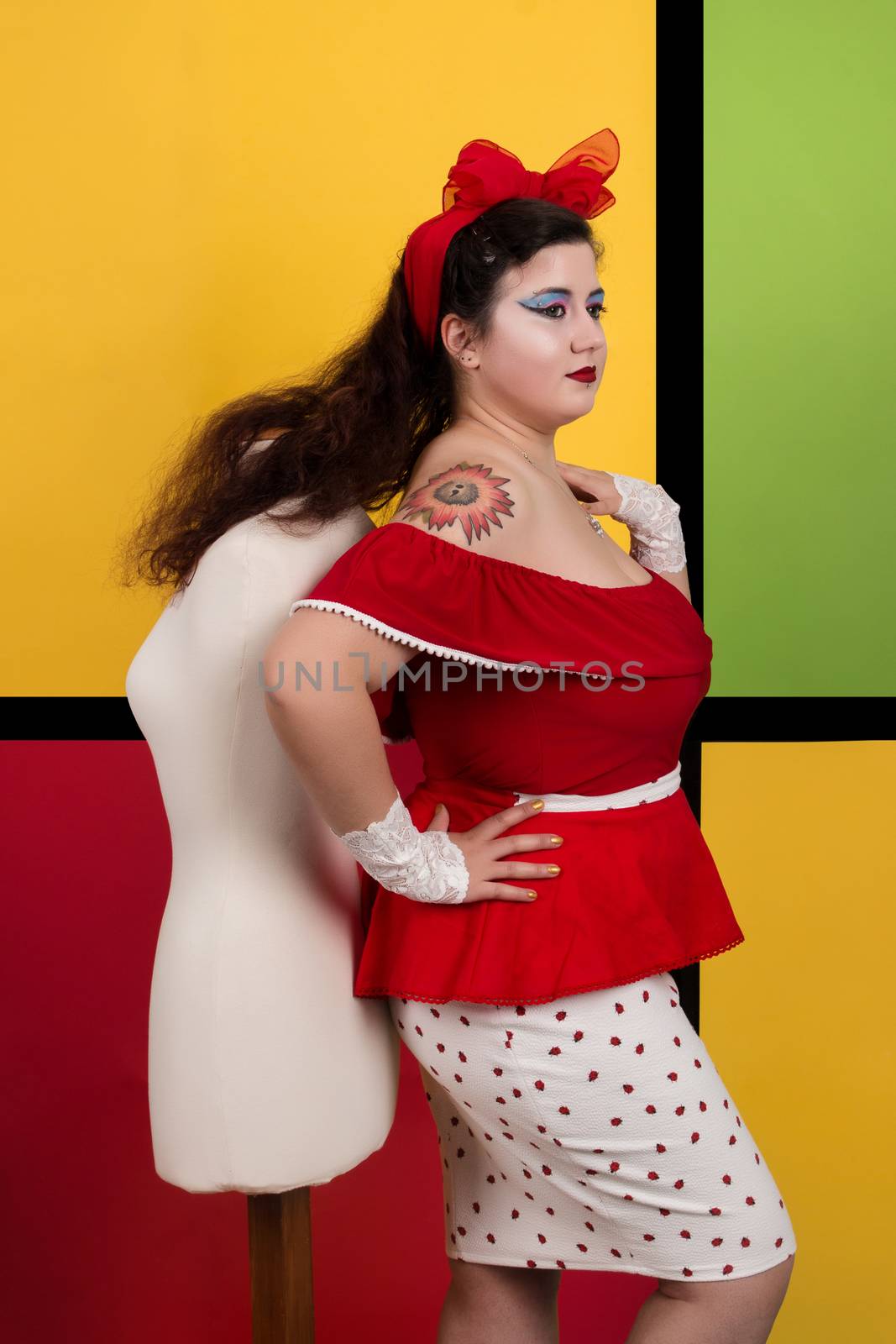 View of pinup vintage girl next to a colorful pop art backdrop.