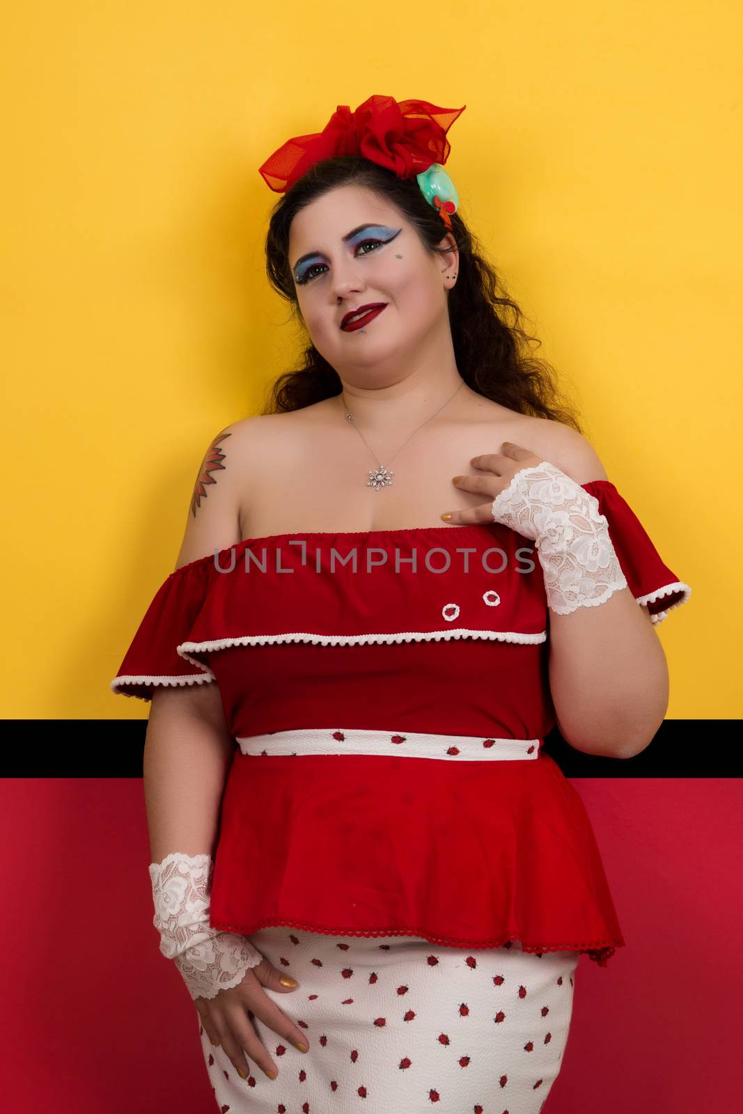 View of pinup vintage girl next to a colorful red and yellow background.