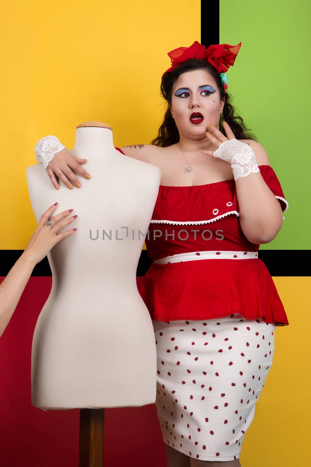 View of pinup vintage girl next to a colorful pop art backdrop.