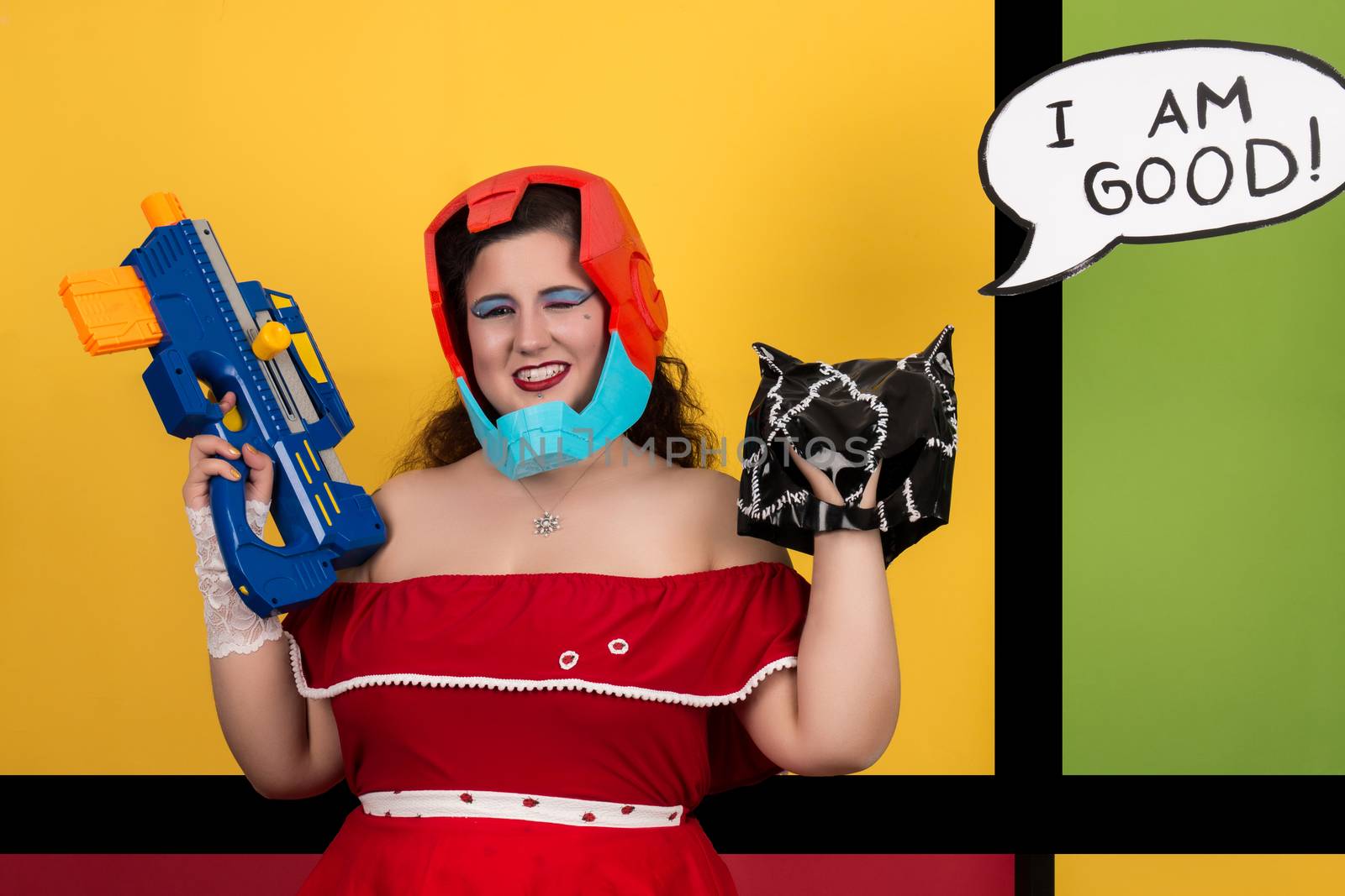 View of pinup vintage girl next to a colorful pop art background holding a nerf weapon.