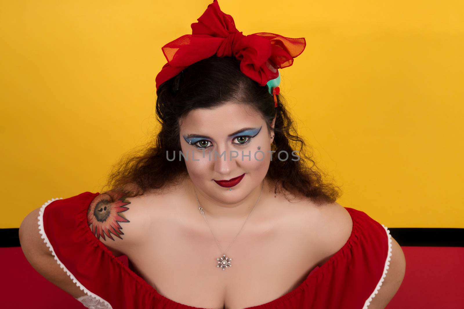 View of pinup vintage girl next to a colorful red and yellow background.