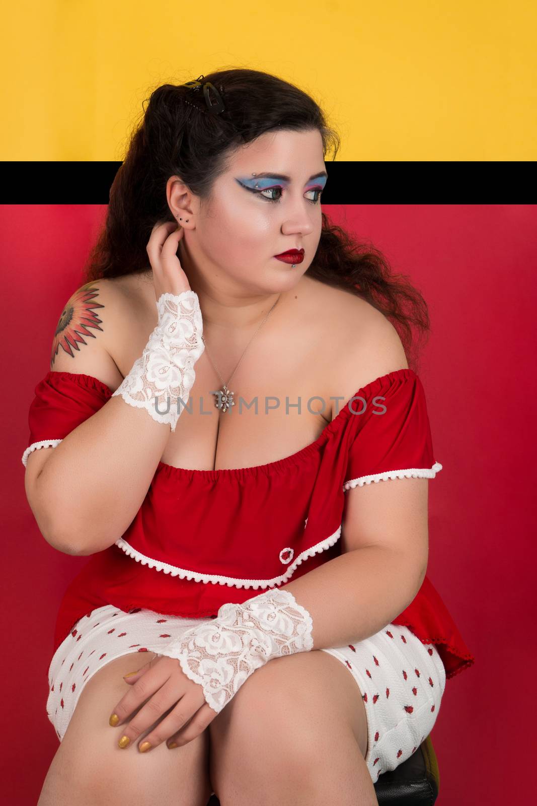 View of pinup vintage girl next to a colorful red and yellow background.