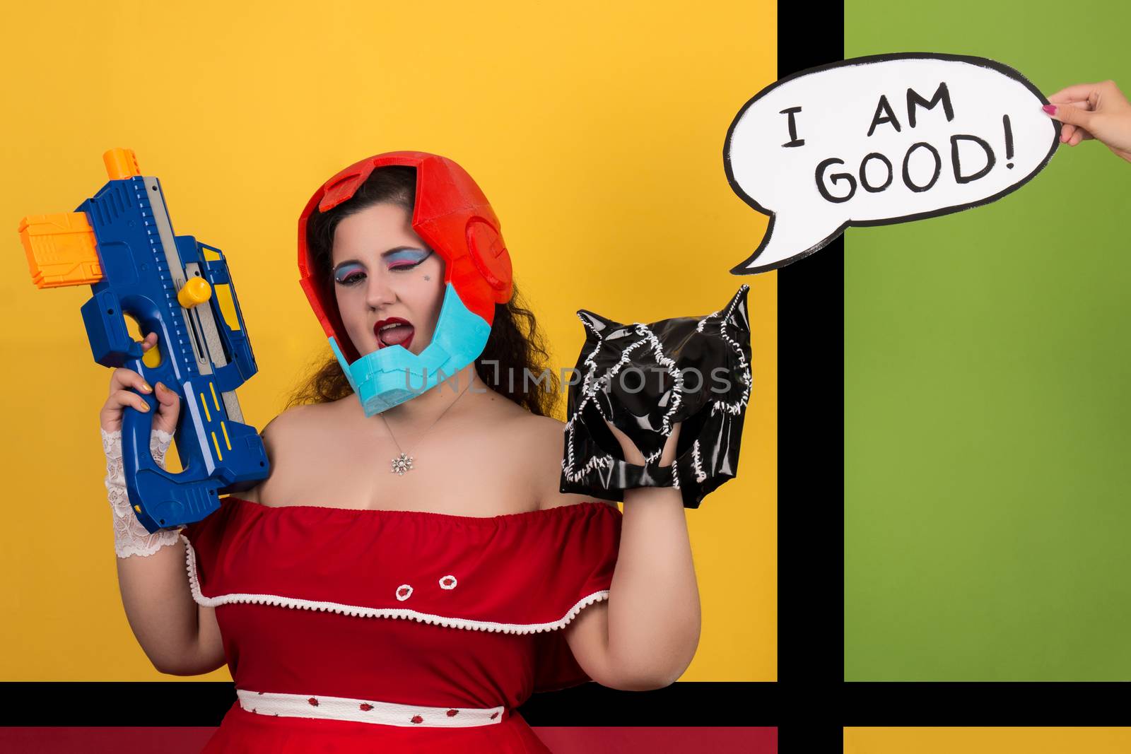 View of pinup vintage girl next to a colorful pop art background holding a nerf weapon.