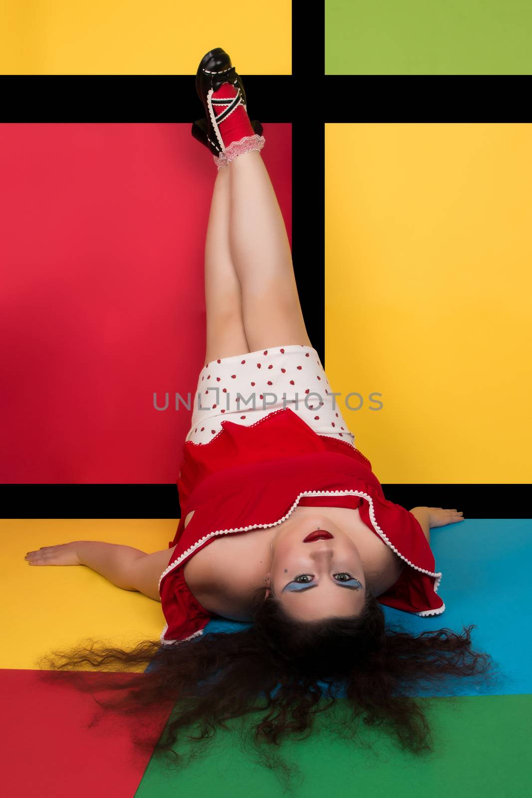 View of pinup vintage girl next to a colorful backdrop.