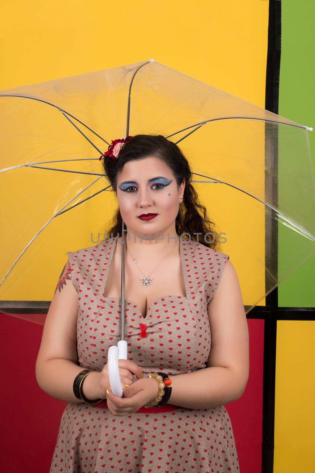 View of pinup vintage girl next to a colorful backdrop.