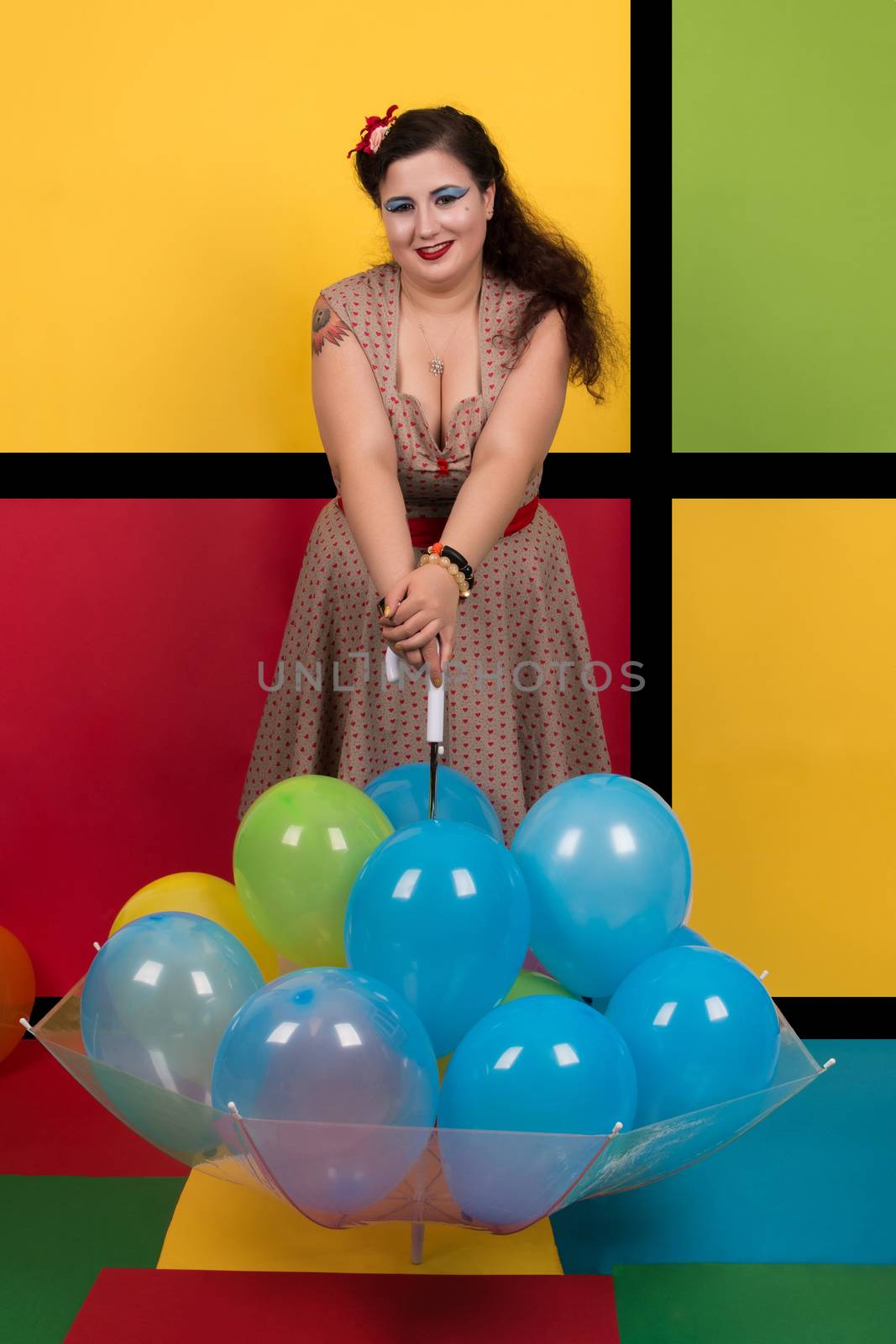 Pinup girl with balloons on a umbrella.