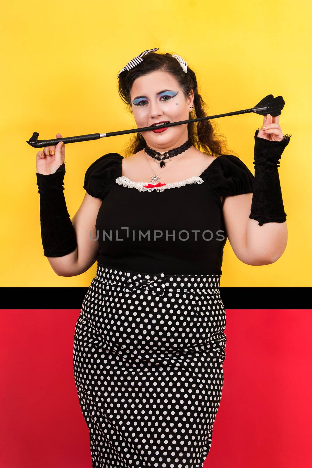 View of pinup vintage girl next to a colorful pop art backdrop.