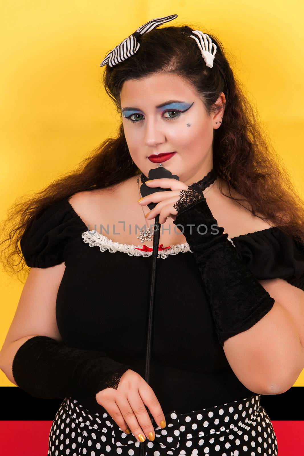 View of pinup vintage girl next to a colorful pop art backdrop.