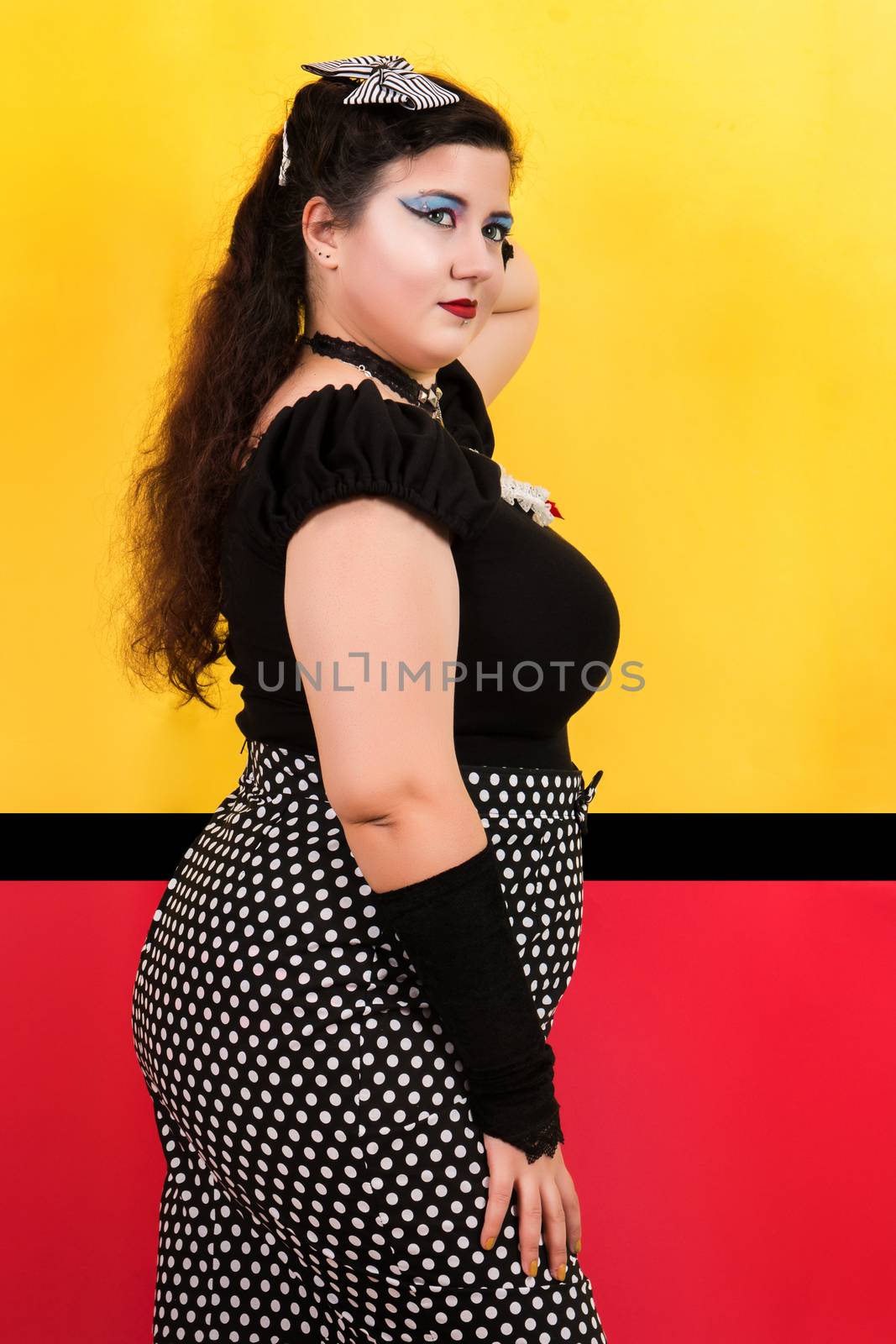 View of pinup vintage girl next to a colorful pop art backdrop.