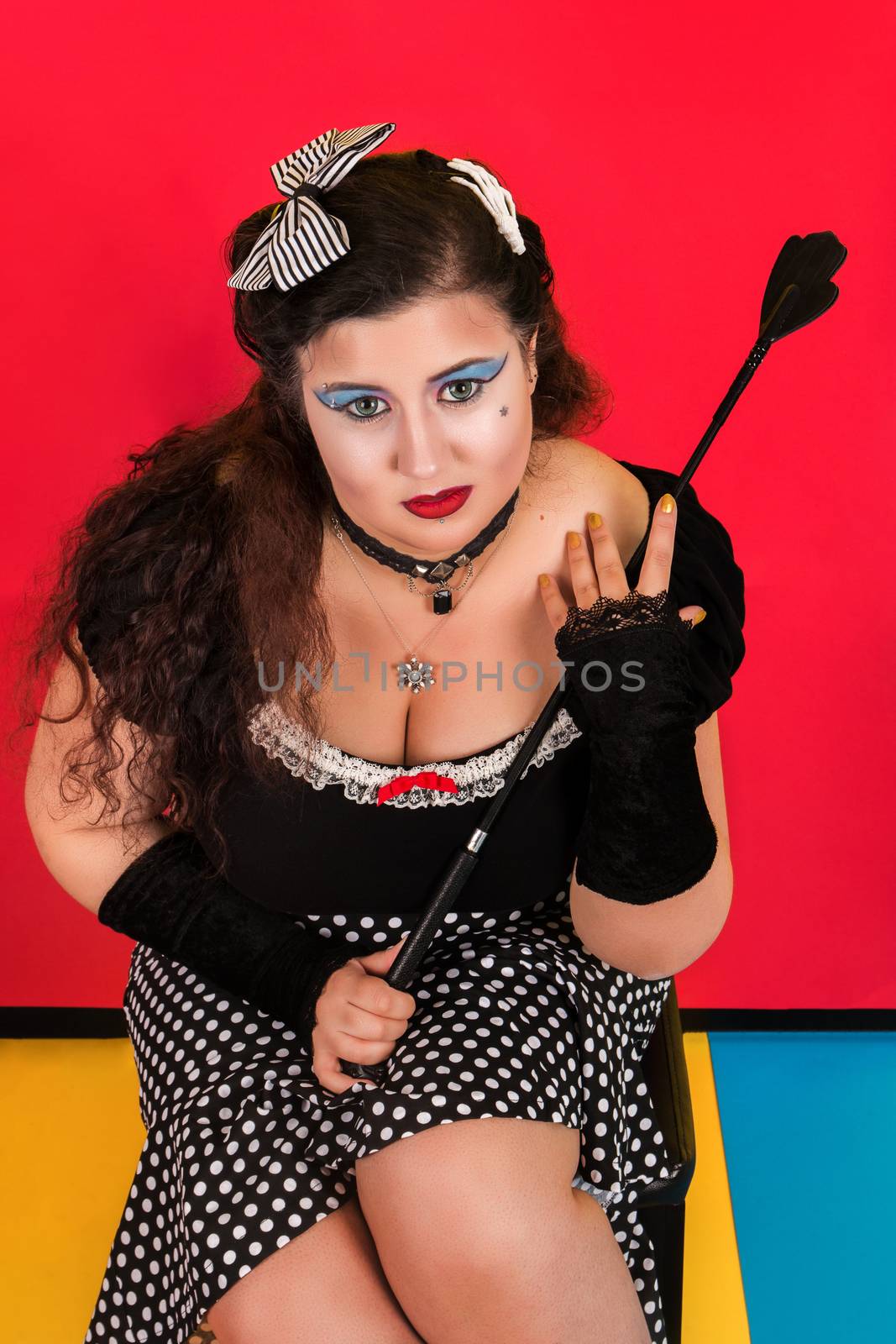 View of pinup vintage girl next to a colorful pop art backdrop.