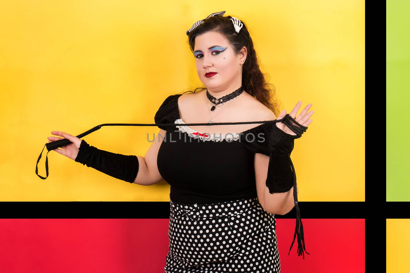 View of pinup vintage girl next to a colorful pop art backdrop.