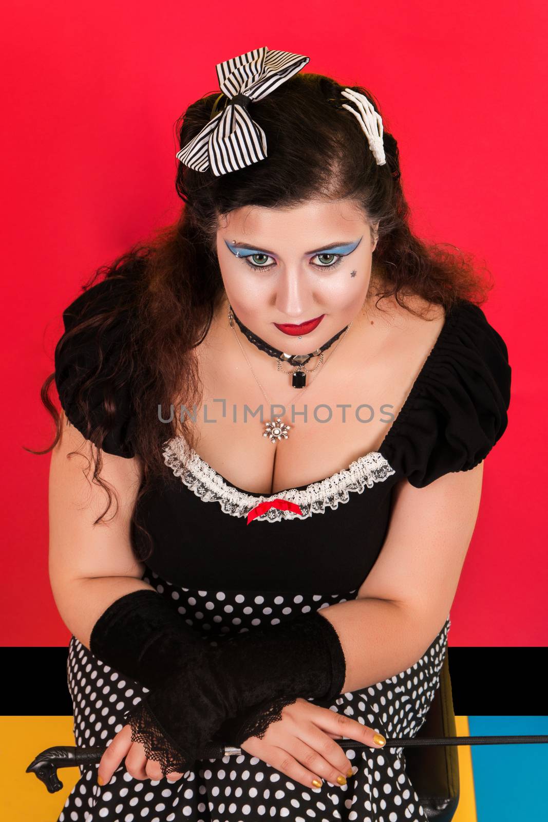 View of pinup vintage girl next to a colorful pop art backdrop.