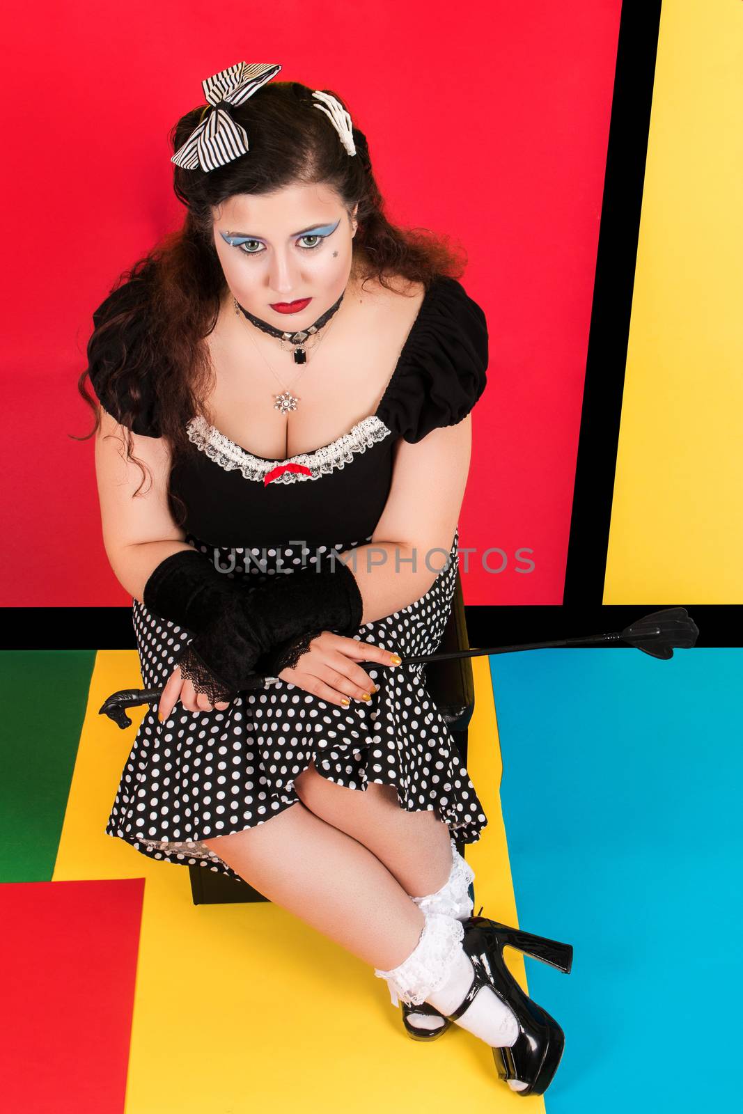 View of pinup vintage girl next to a colorful pop art backdrop.