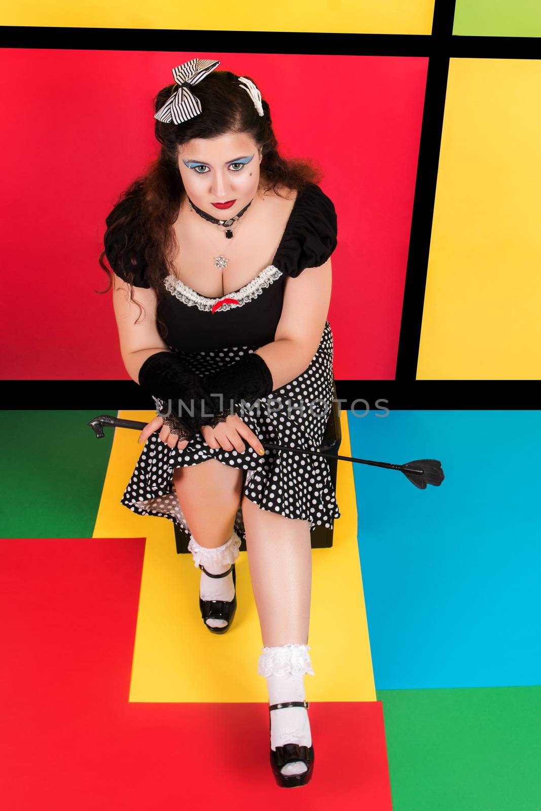 View of pinup vintage girl next to a colorful pop art backdrop.