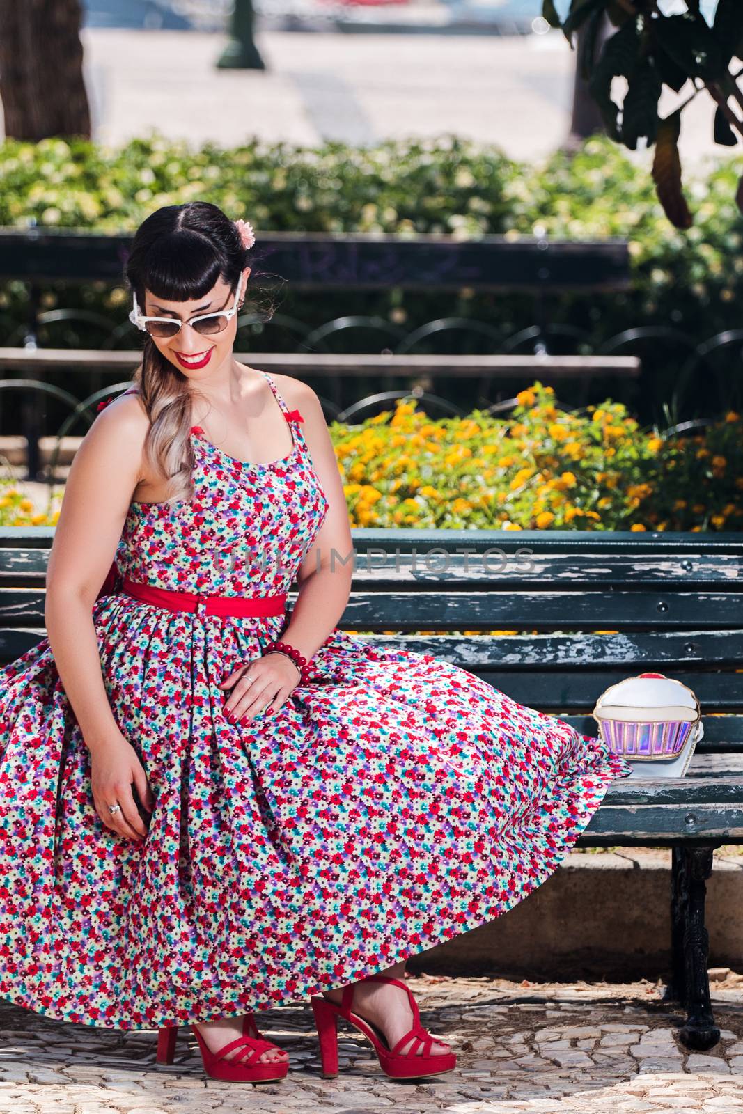 Pinup girl relaxing in the park by membio