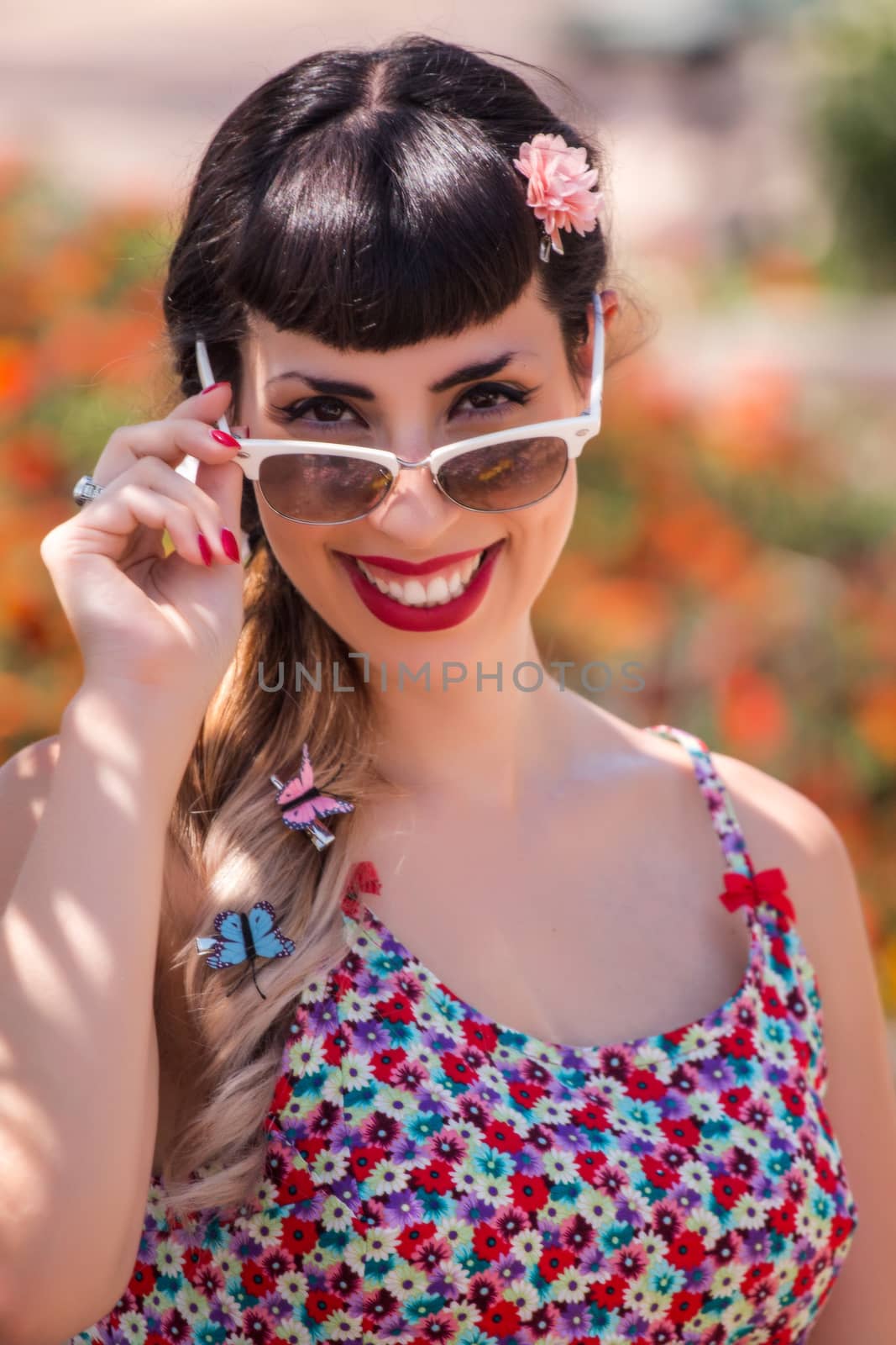 Pinup girl  with dress relaxing in the beautiful urban park.