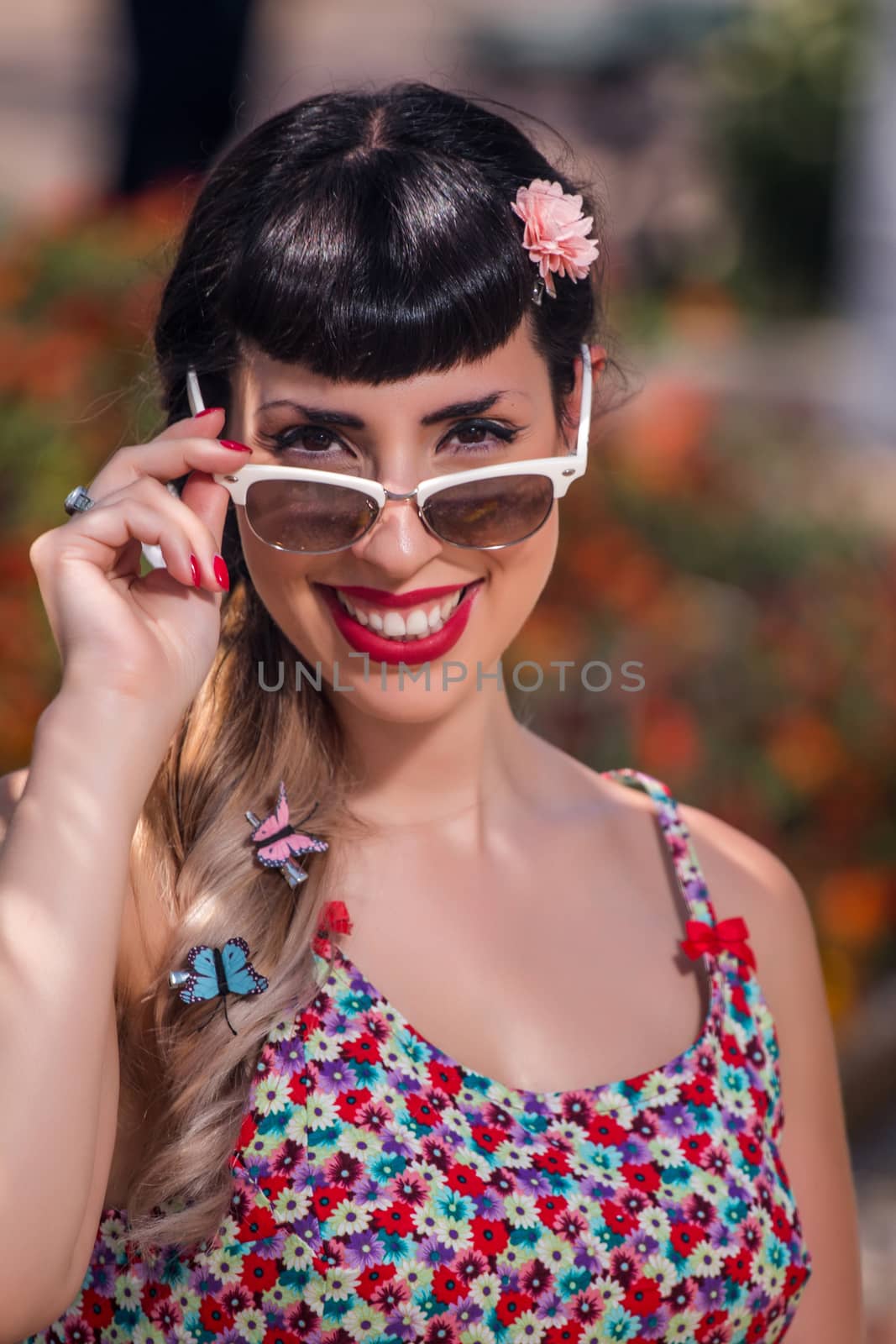 Pinup girl  with dress relaxing in the beautiful urban park.