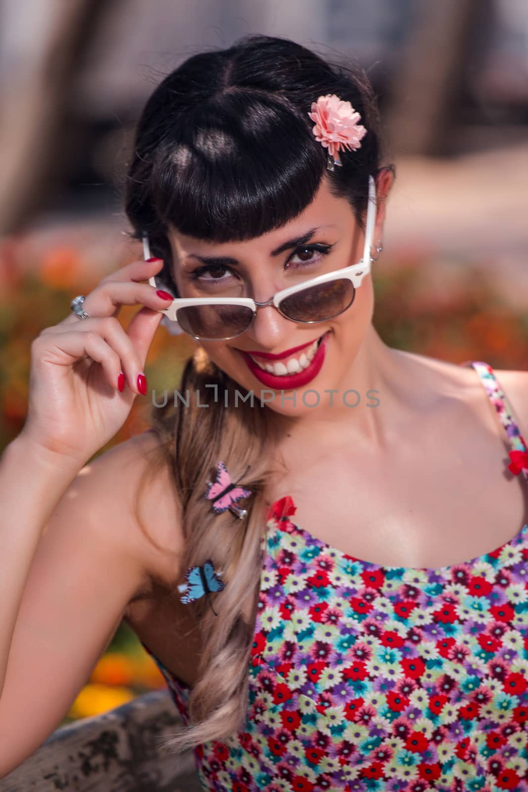 Pinup girl  with dress relaxing in the beautiful urban park.