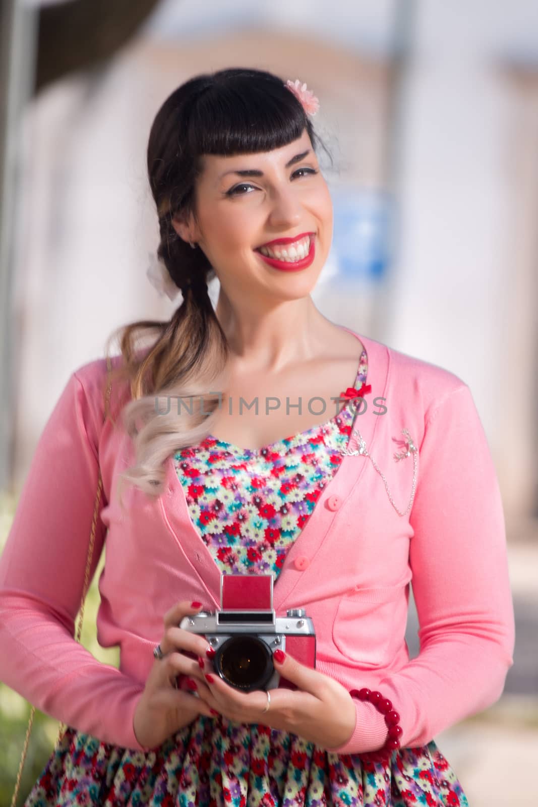 Pinup girl using a vintage camera by membio