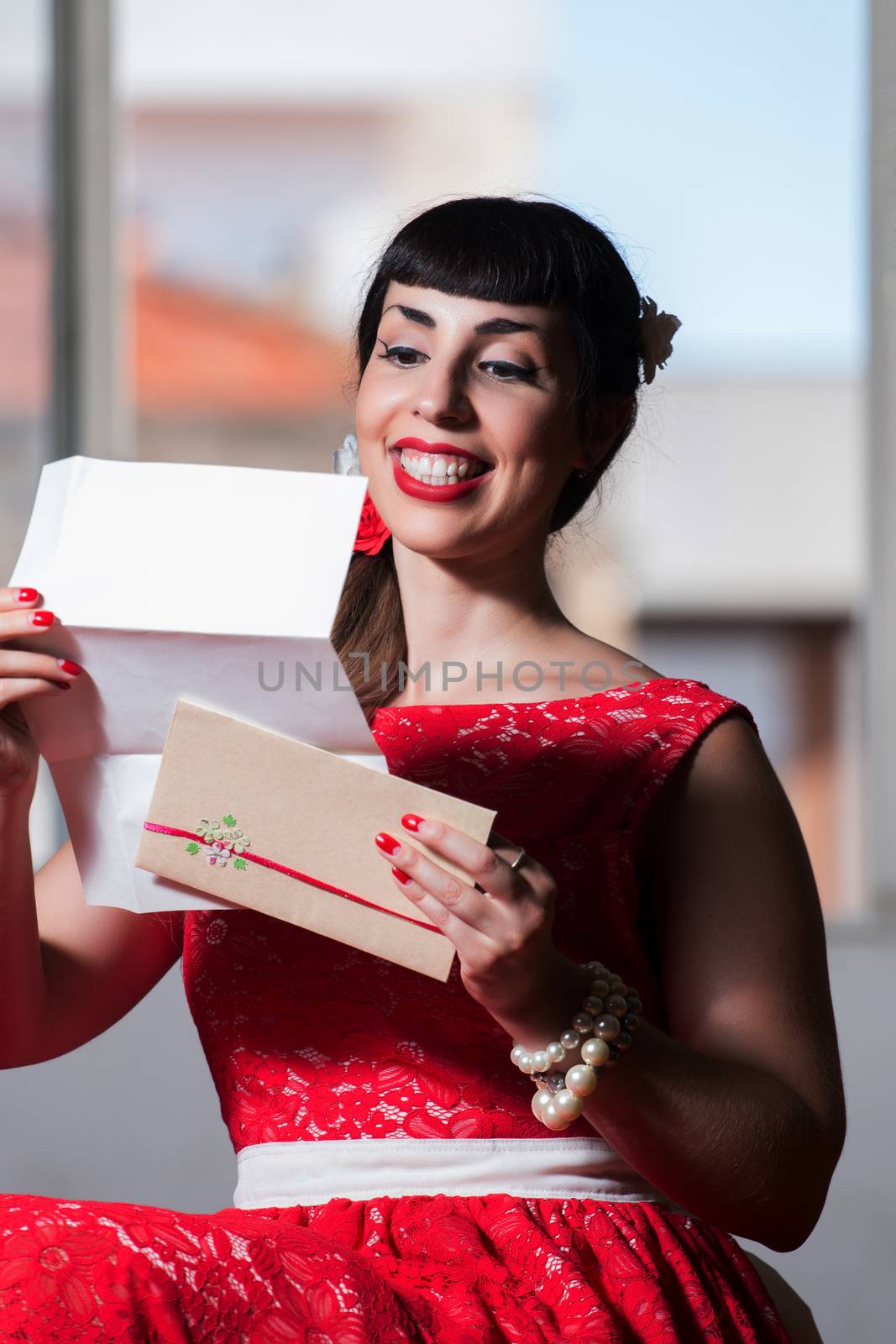 Pinup girl with red dress reading a romantic letter.