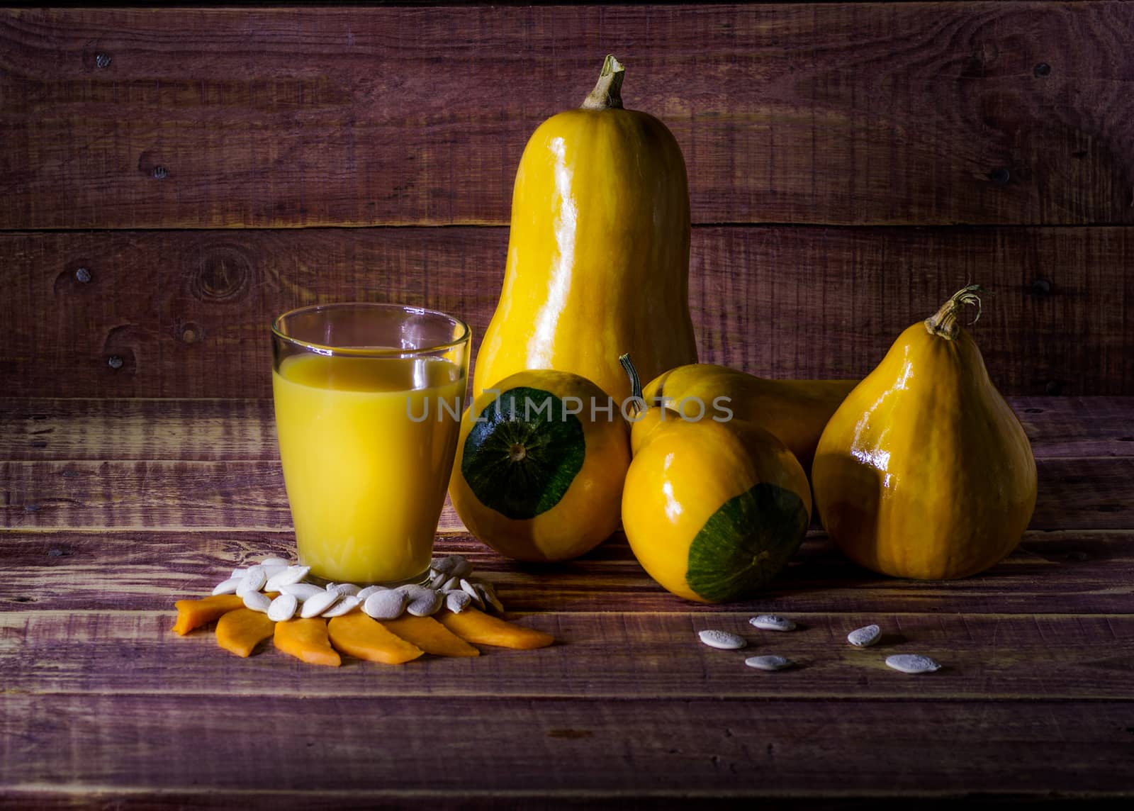 still life with pumpkin and pumpkin juice on a wooden table