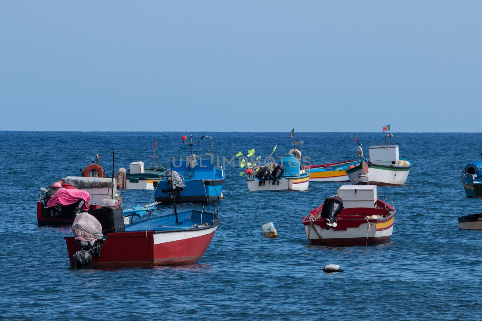 Traditional fishing boats on the shoreline of Camara de Lobos, Madeira.