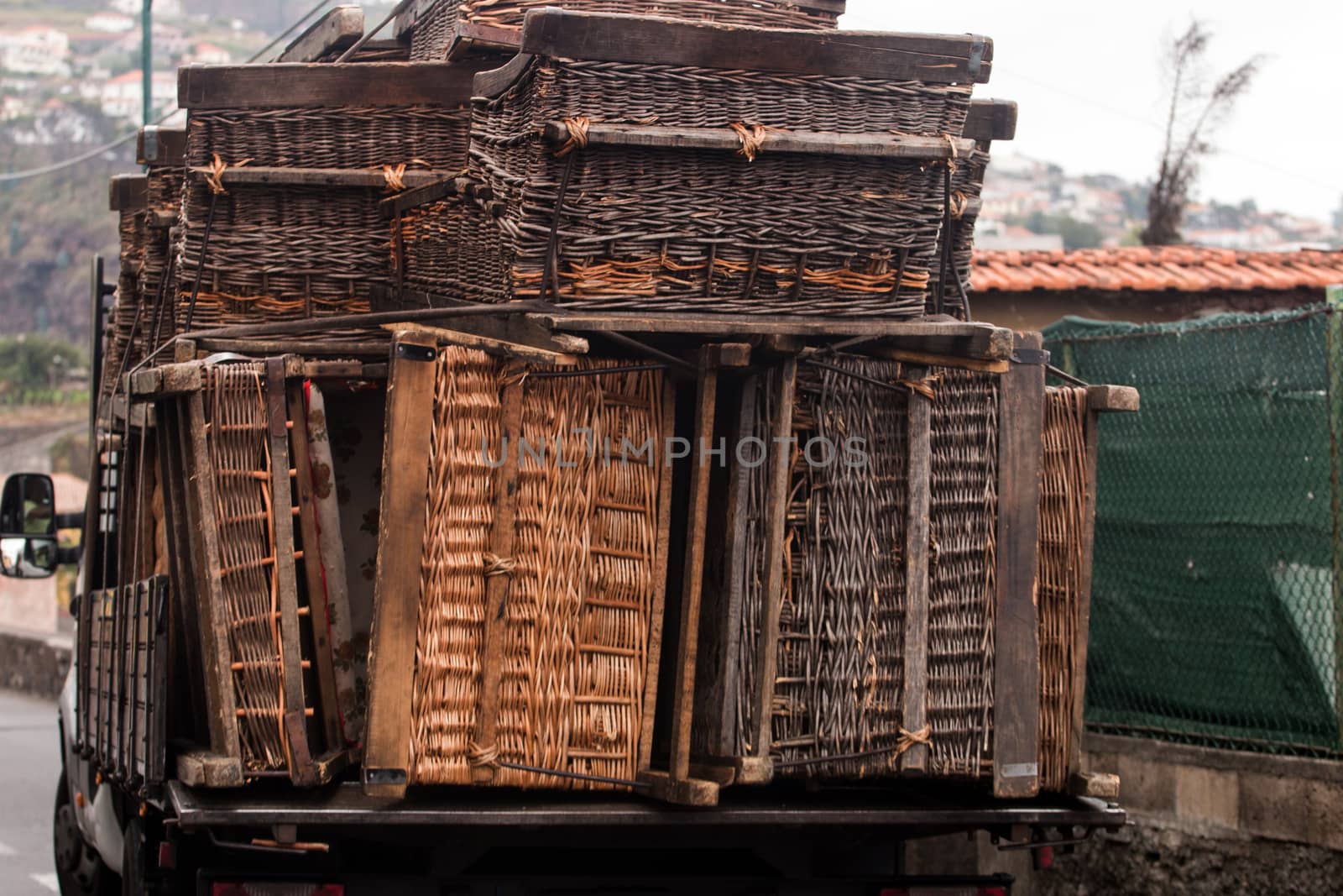 Truck carrying a bunch of toboggan basket cars.