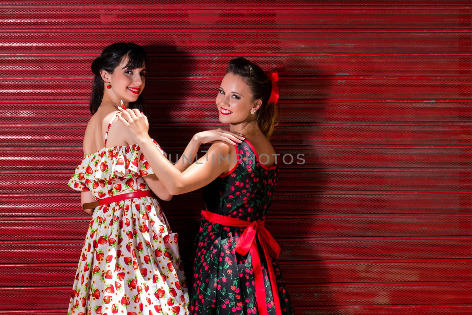 Women posing with a vintage style retro floral clothing.