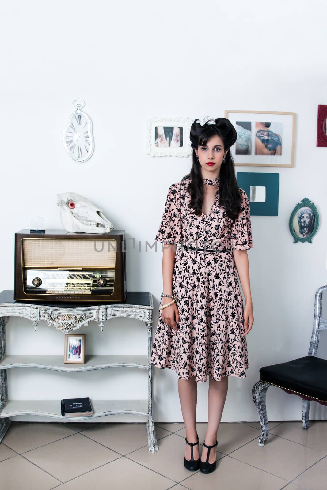 Woman posing with a vintage style retro floral clothing.