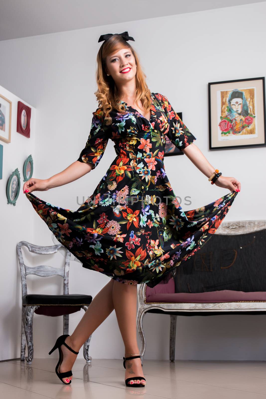 Woman posing with a vintage style retro floral clothing.