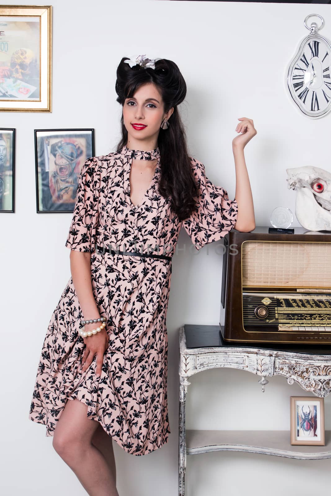 Woman posing with a vintage style retro floral clothing.