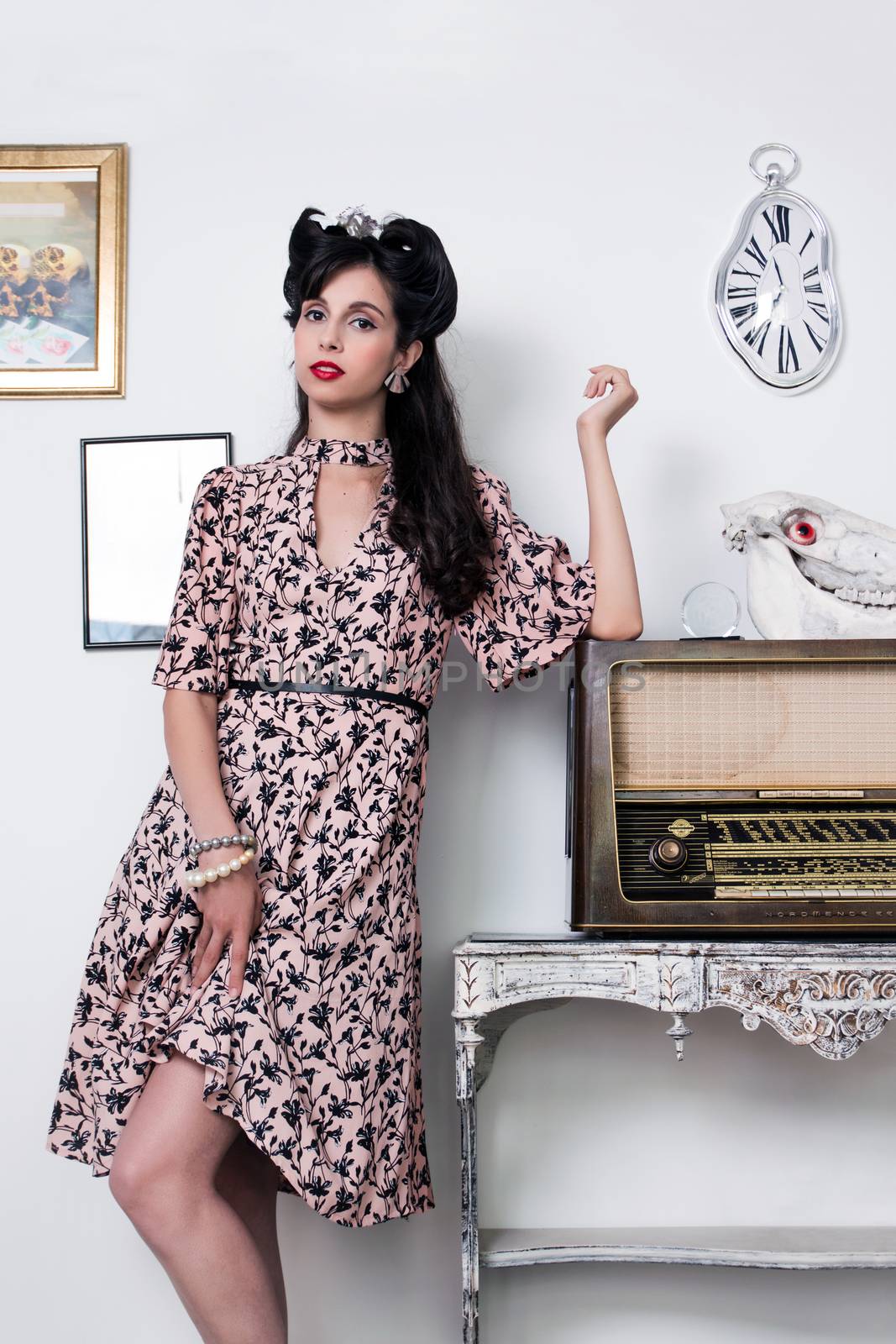 Woman posing with a vintage style retro floral clothing.