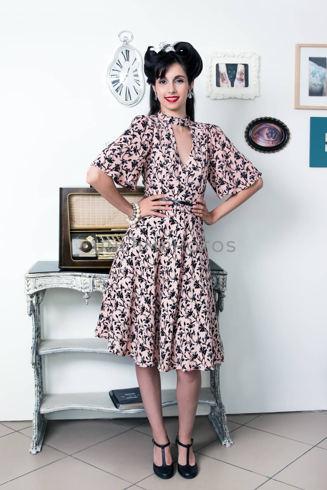 Woman posing with a vintage style retro floral clothing.