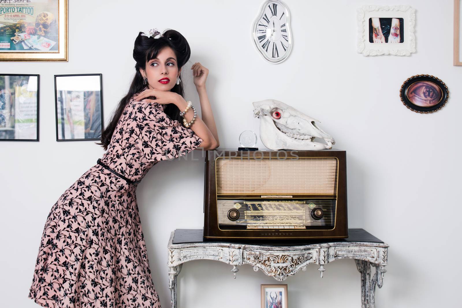 Woman posing with a vintage style retro floral clothing.