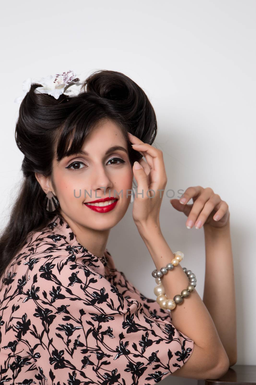 Woman posing with a vintage style retro floral clothing.