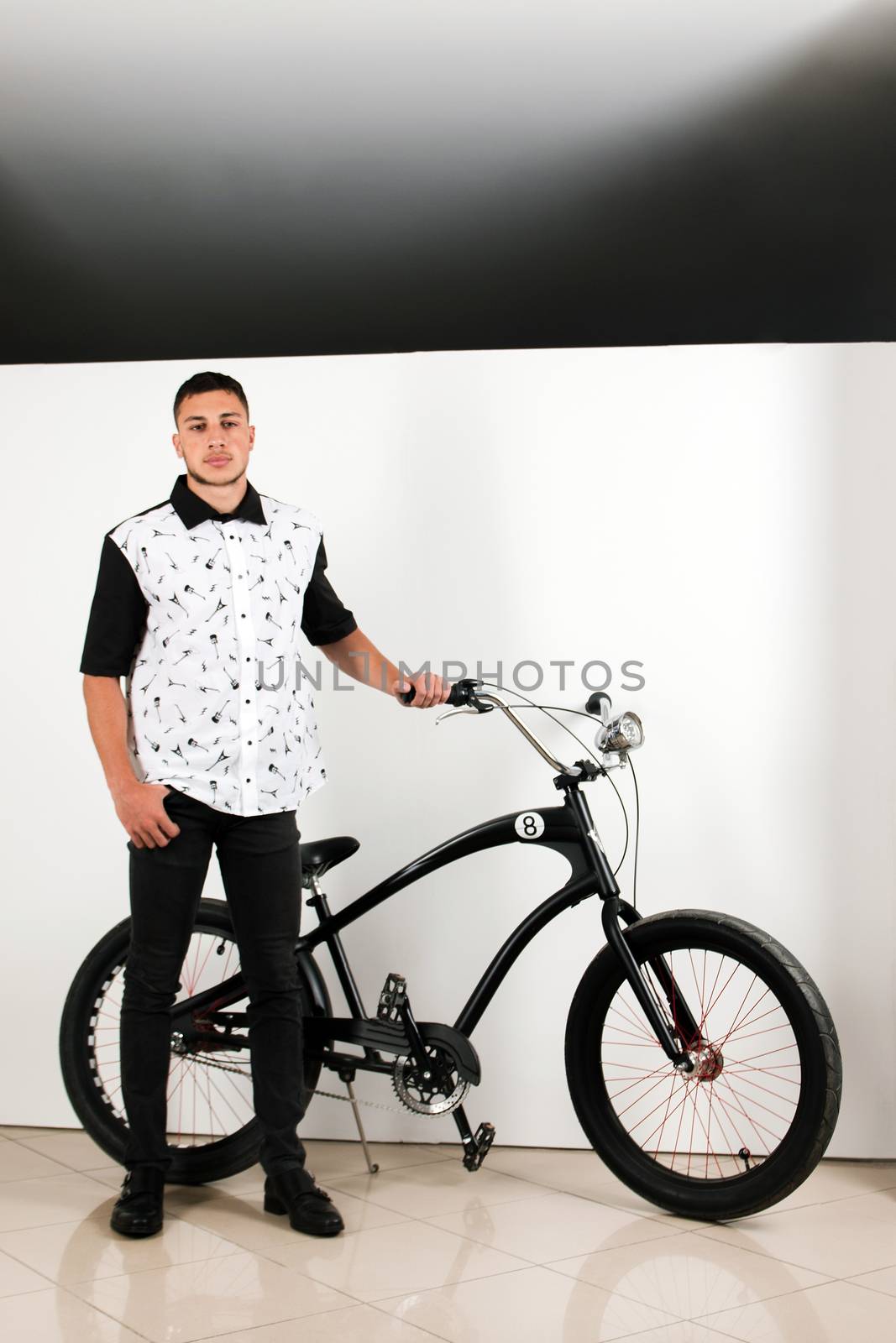 Teenager posing with a vintage style retro clothing and a bike.