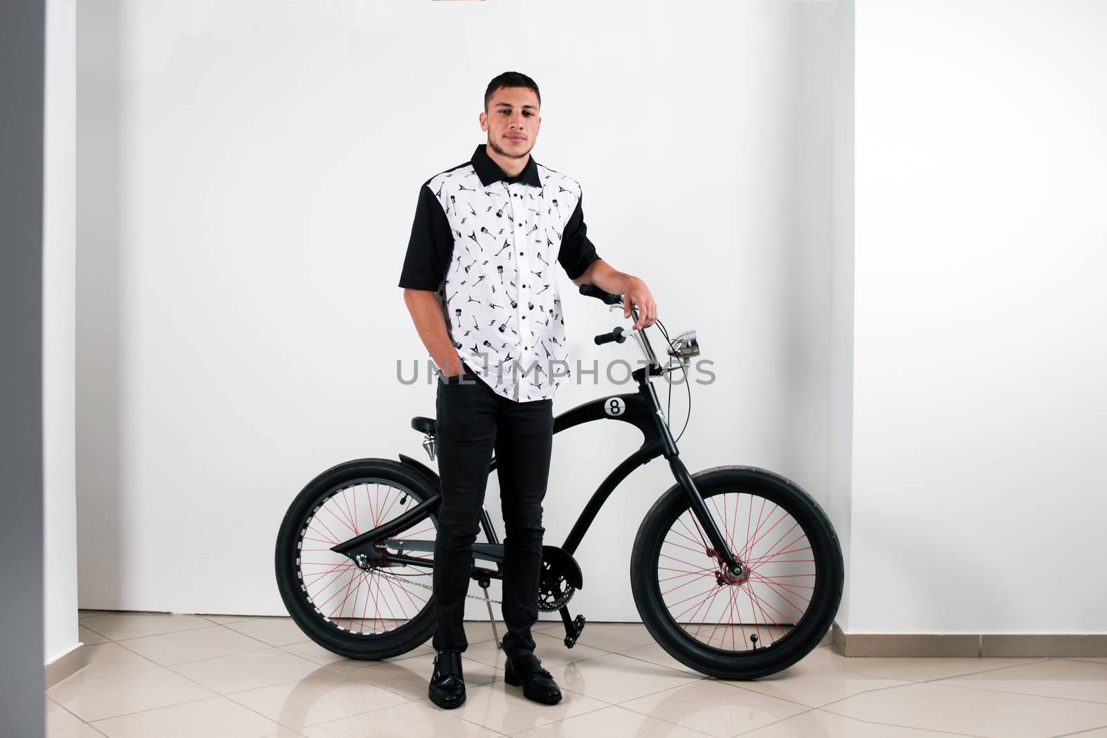 Teenager posing with a vintage style retro clothing and a bike.