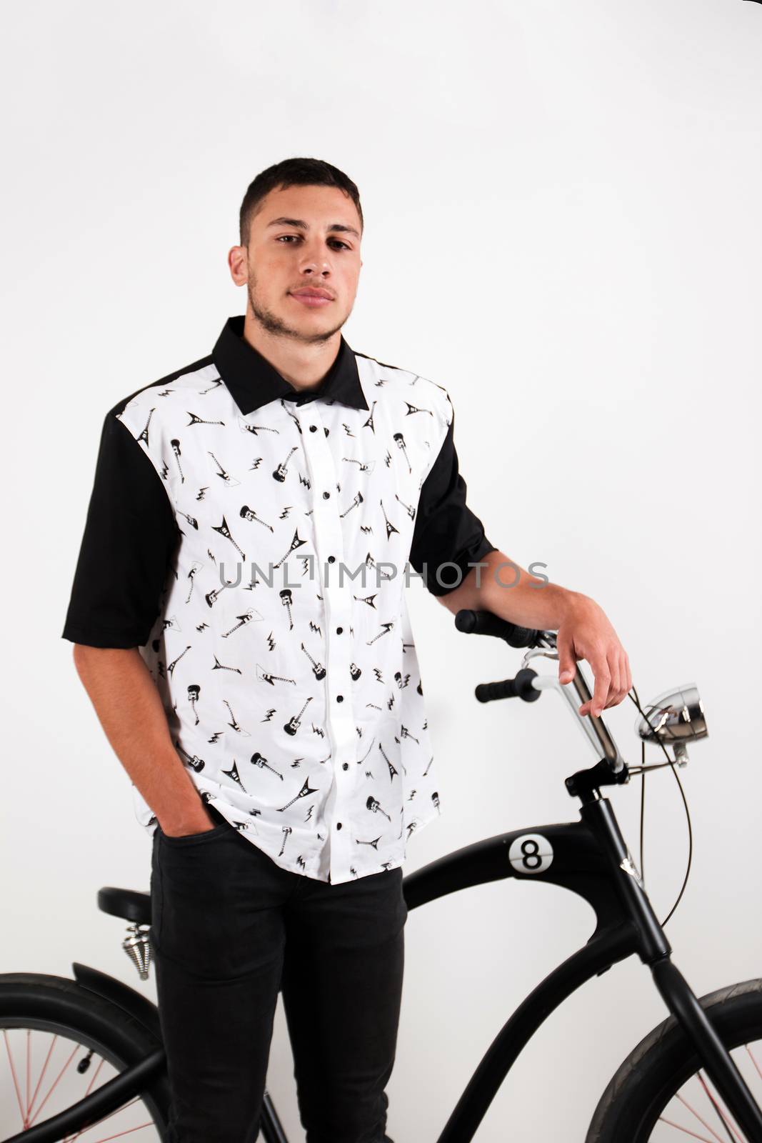 Teenager posing with a vintage style retro clothing and a bike.