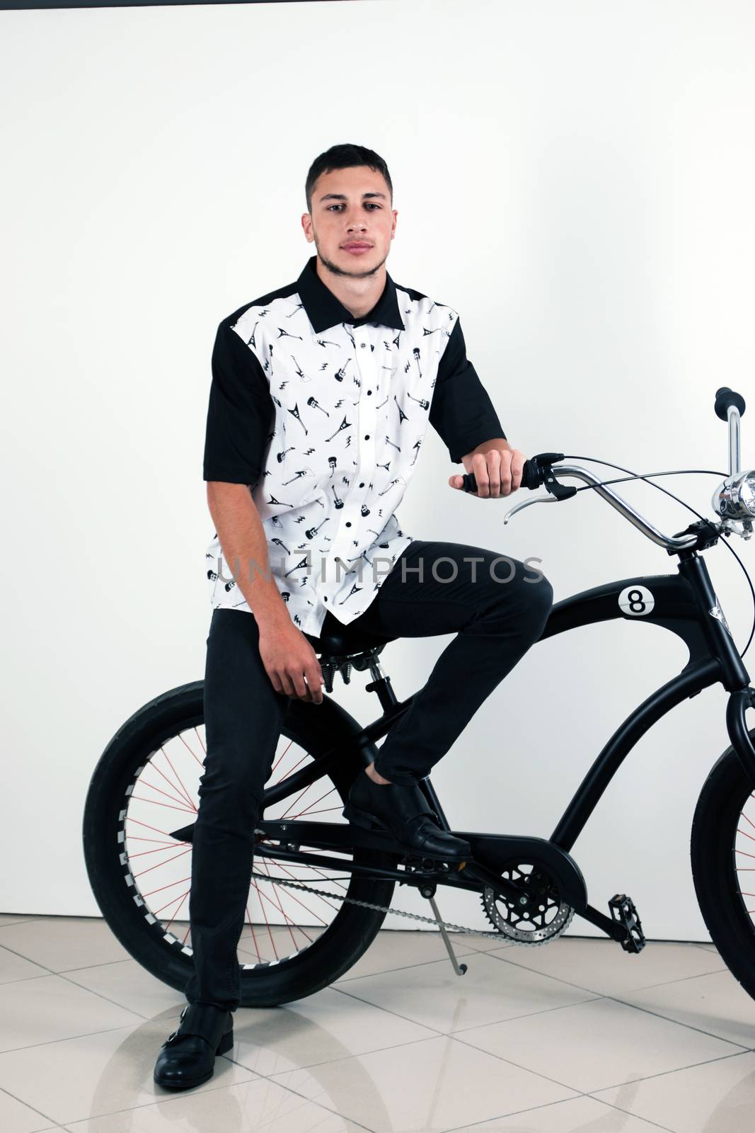 Teenager posing with a vintage style retro clothing and a bike.