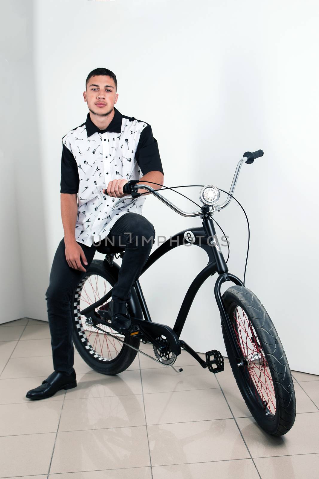 Teenager posing with a vintage style retro clothing and a bike.