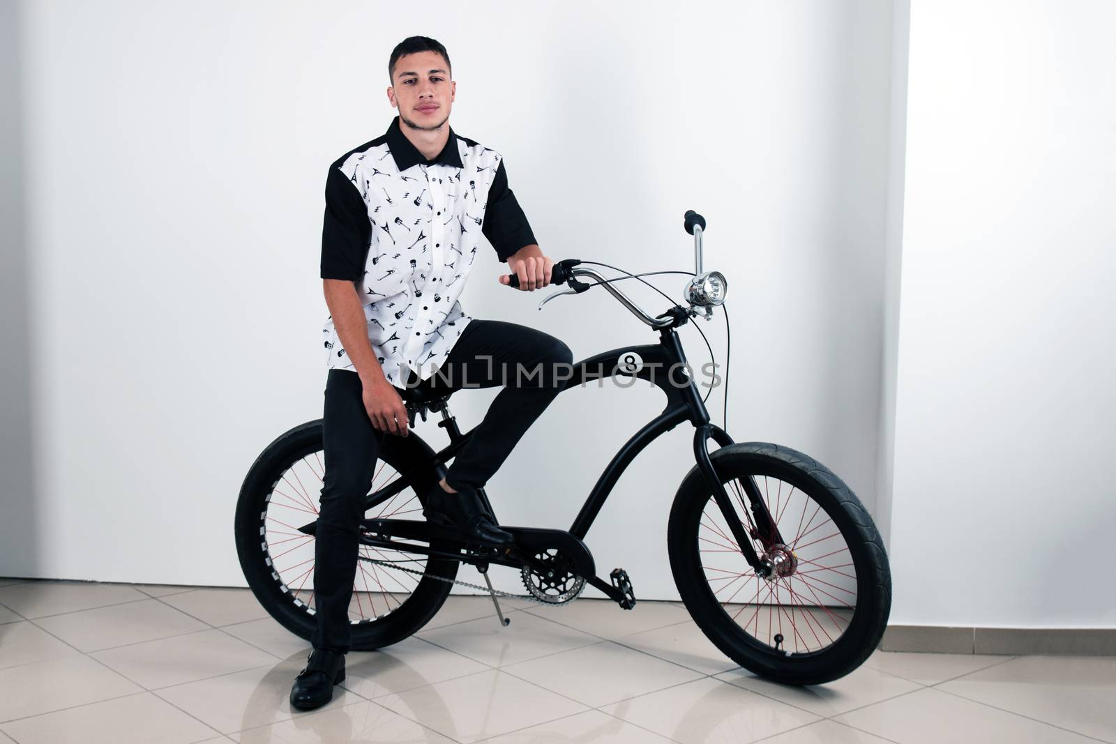 Teenager posing with a vintage style retro clothing and a bike.