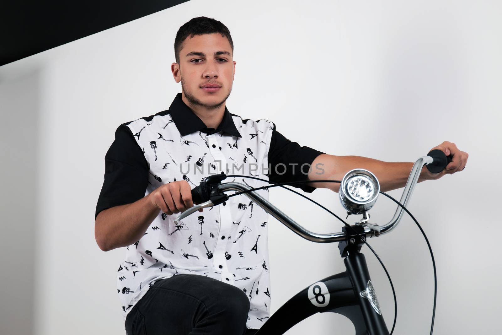 Teenager posing with a vintage style retro clothing and a bike.