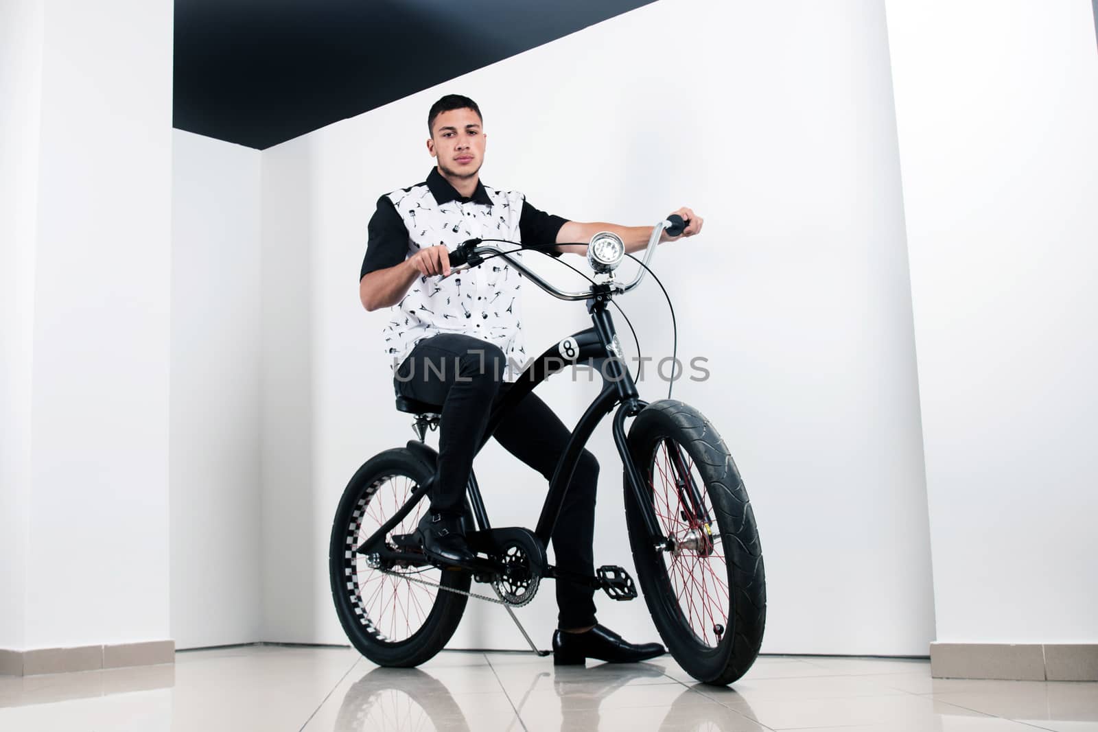 Teenager posing with a vintage style retro clothing and a bike.