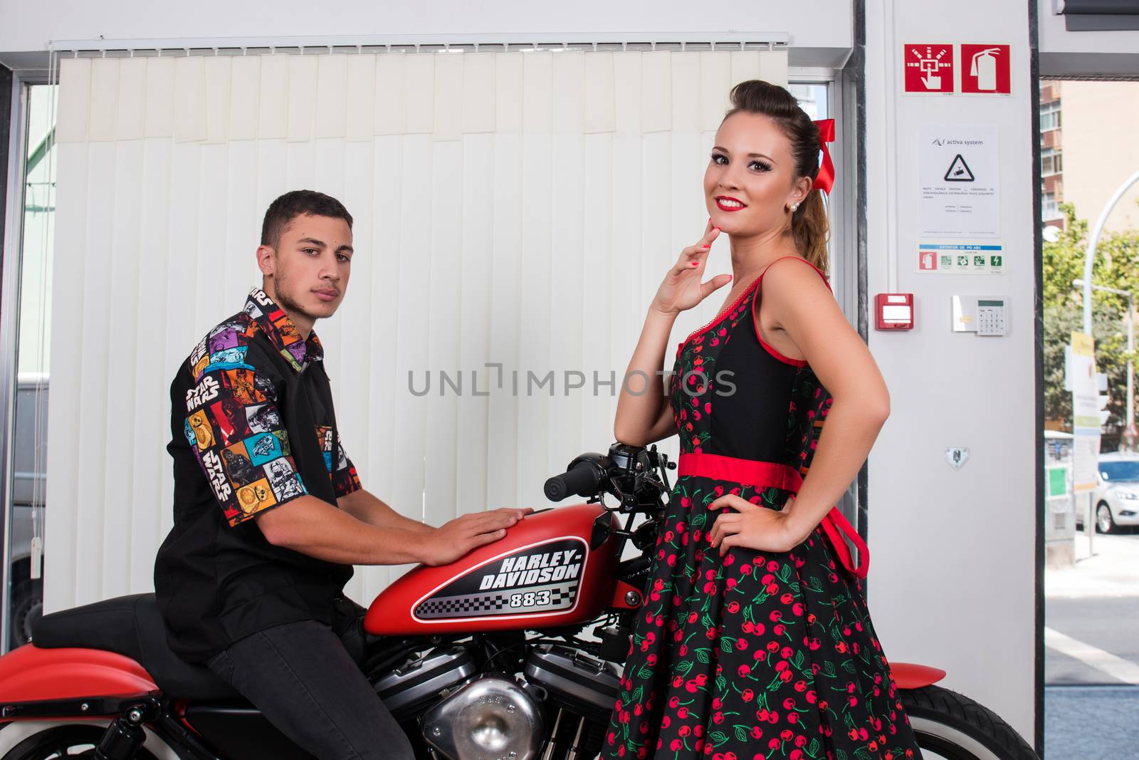 Close up of a couple using vintage clothing on a motorbike.