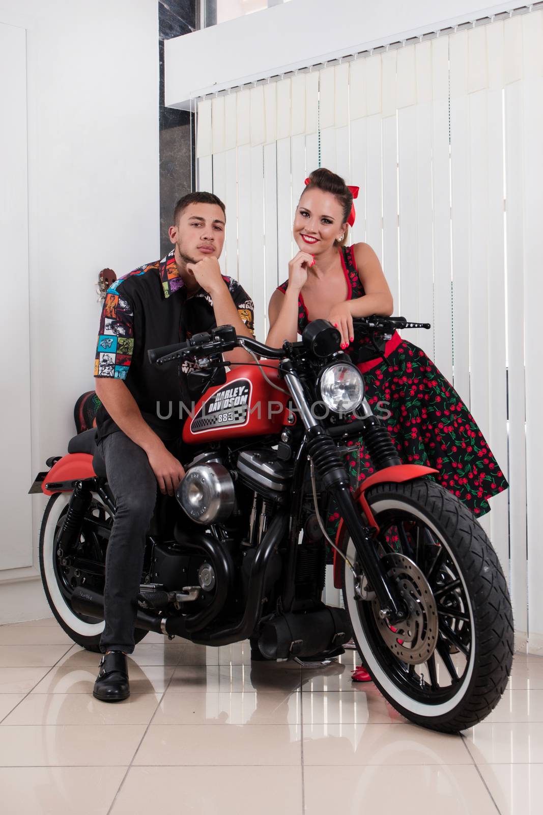 Close up of a couple using vintage clothing on a motorbike.