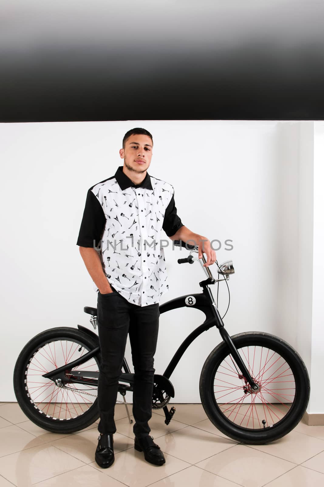 Teenager posing with a vintage style retro clothing and a bike.