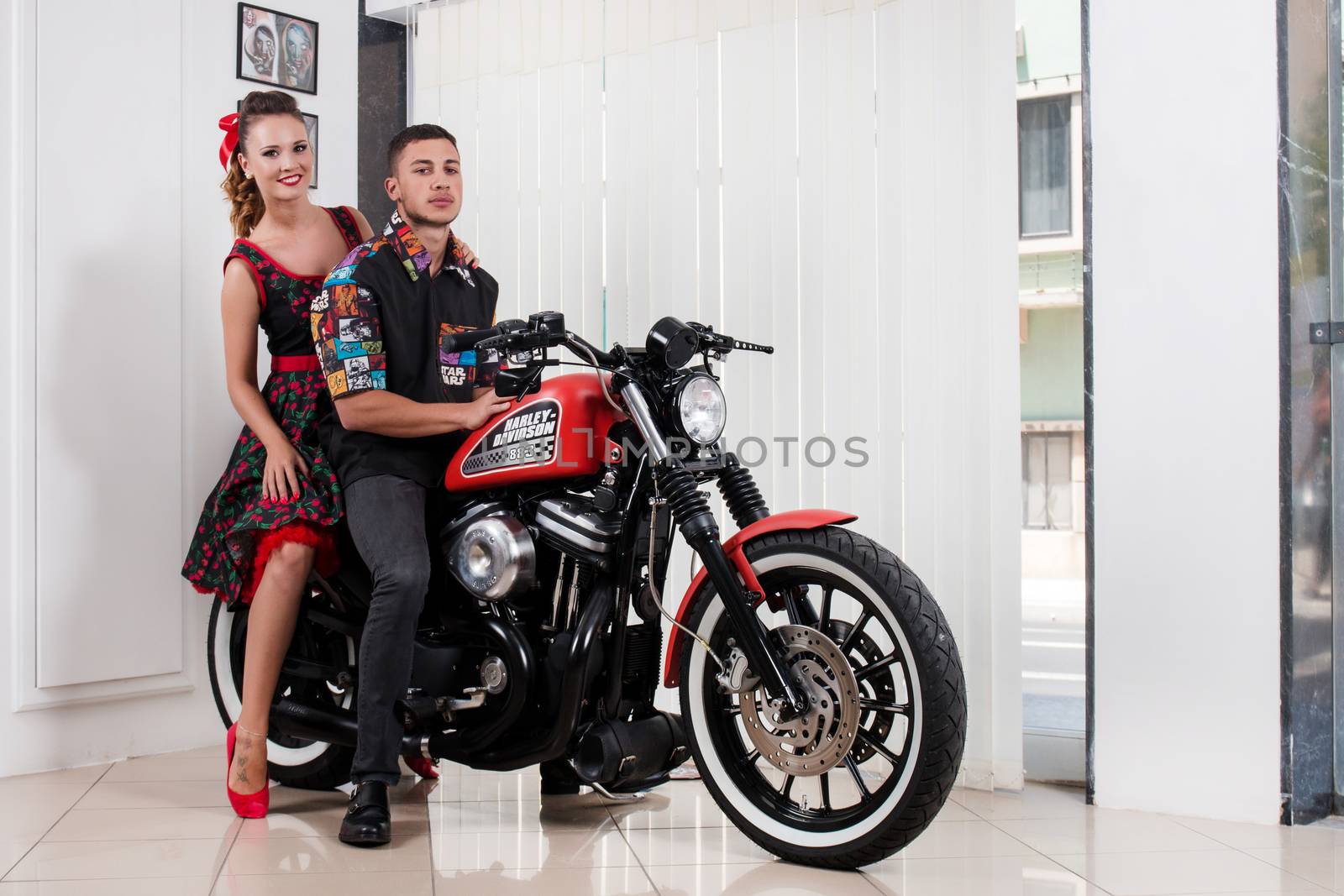 Close up of a couple using vintage clothing on a motorbike.