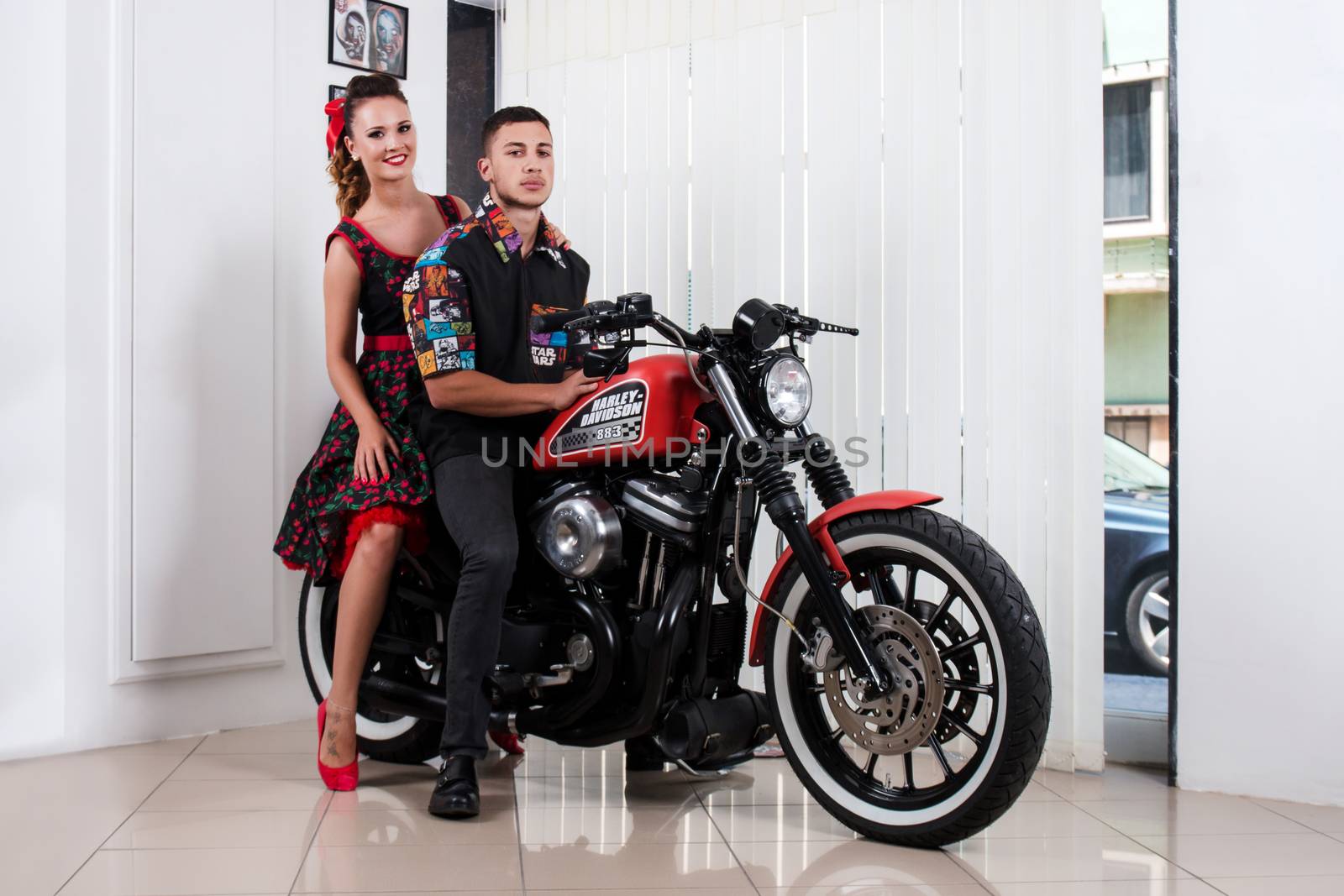 Close up of a couple using vintage clothing on a motorbike.